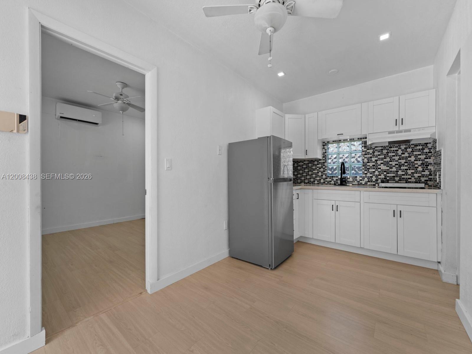 a kitchen with stainless steel appliances kitchen island granite countertop a refrigerator and a stove top oven