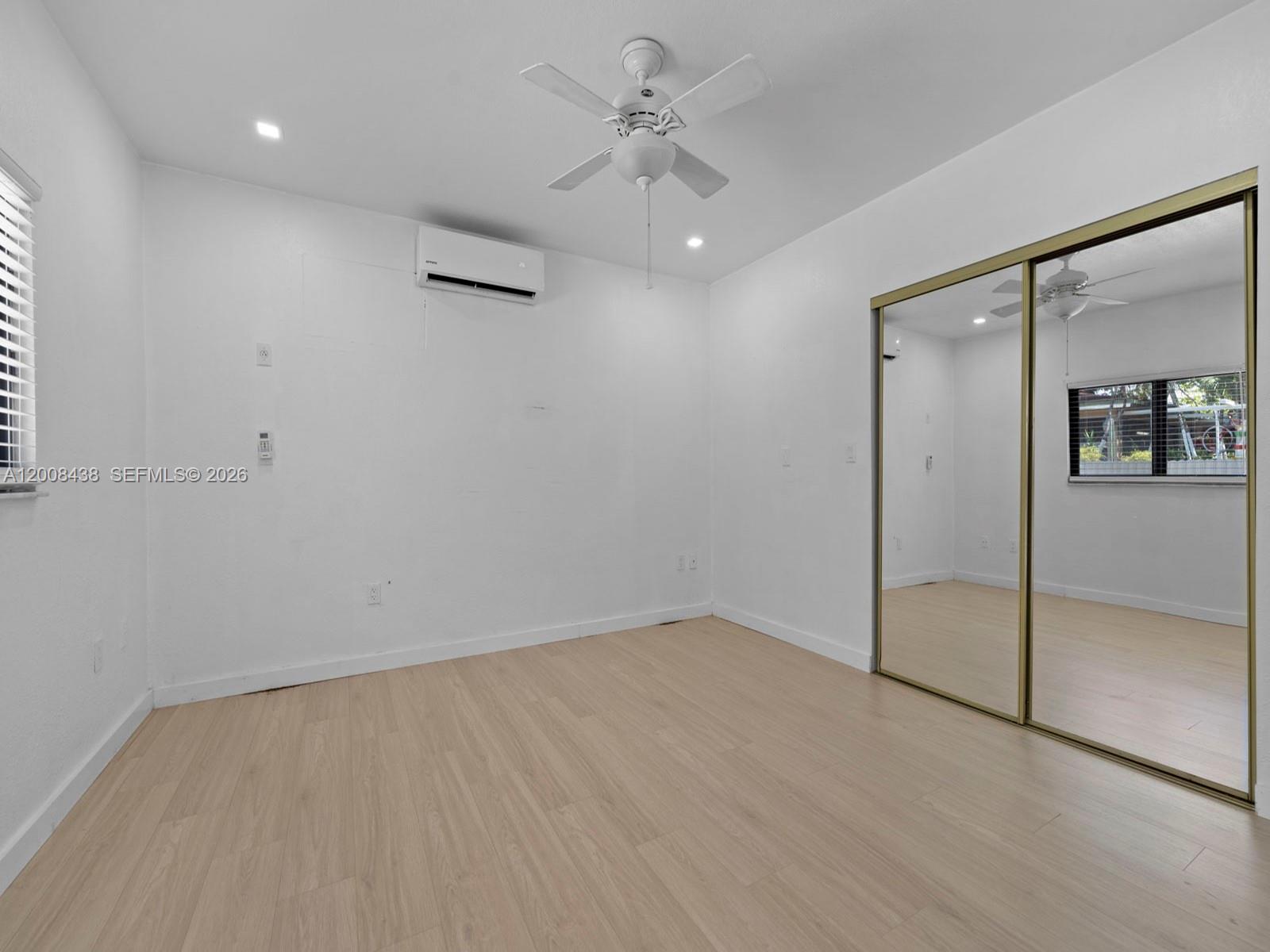252 East 36th Street, Unit A Hialeah, FL 33013 - Photo 2 of 10 wooden floor in an empty room with a window