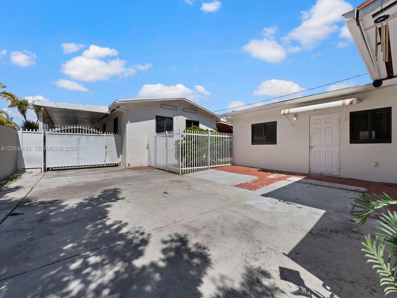 252 East 36th Street, Unit A Hialeah, FL 33013 - Photo 9 of 10 a view of a white house with a yard
