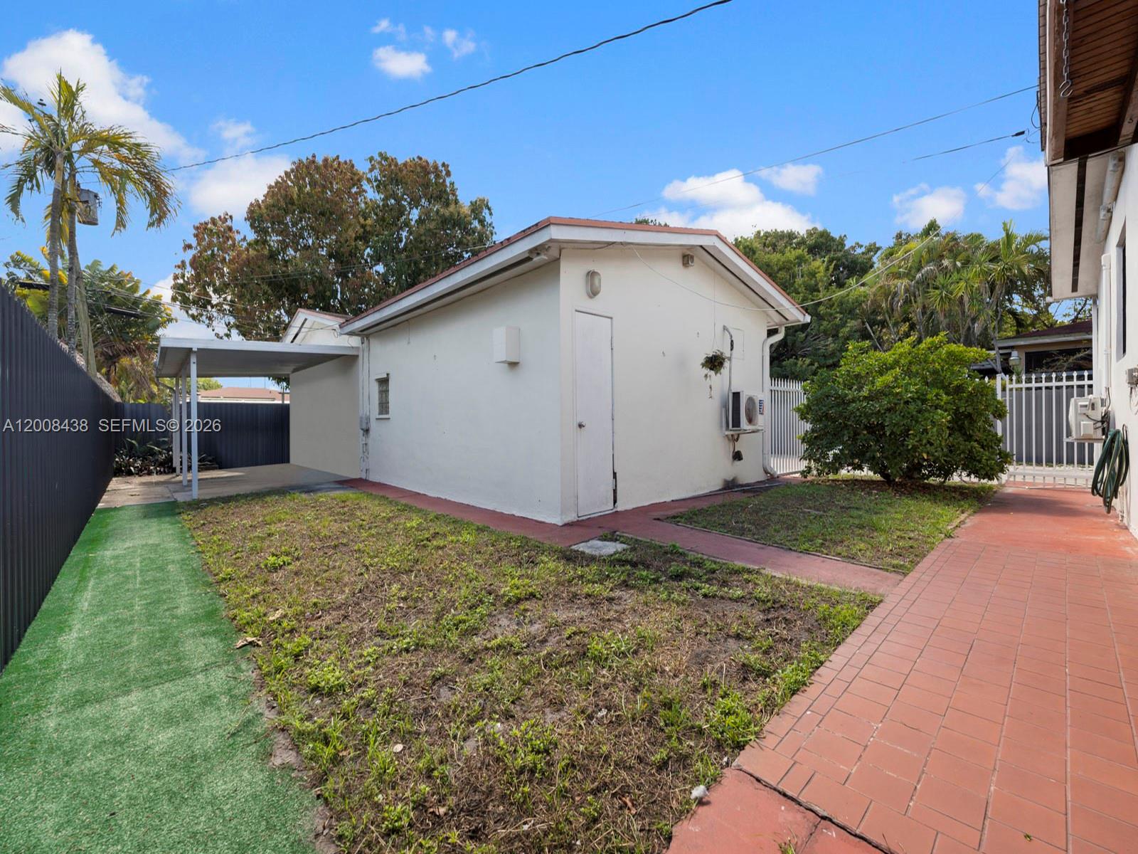 252 East 36th Street, Unit A Hialeah, FL 33013 - Photo 10 of 10 a view of a white house with a yard