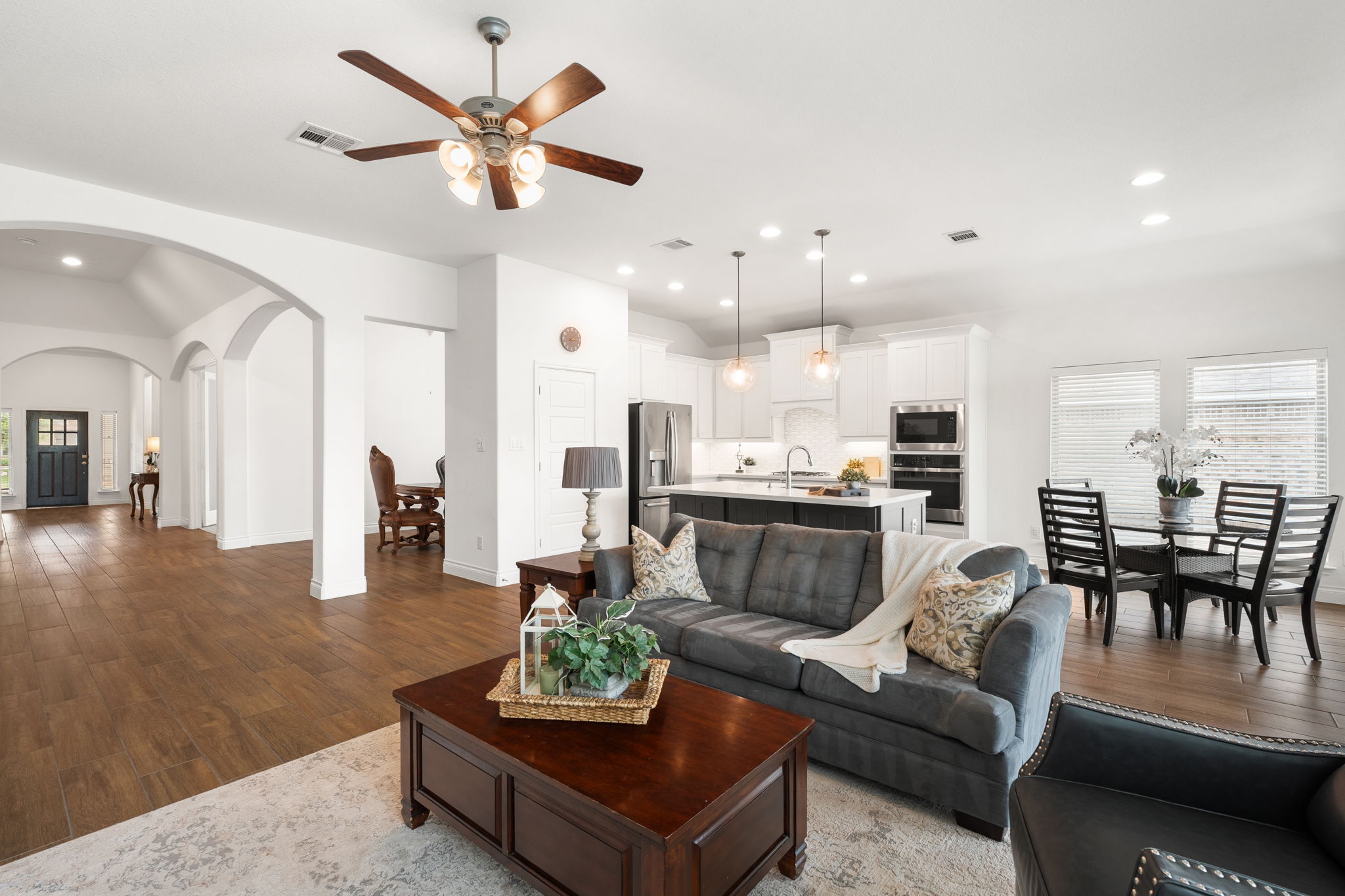 1908 Woolsey Way Leander, TX 78641 - Photo 7 of 36 An airy, open-concept living area flows seamlessly into a nearby dining space.