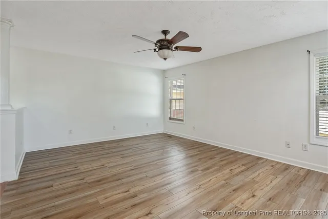 wooden floor in an empty room with a window
