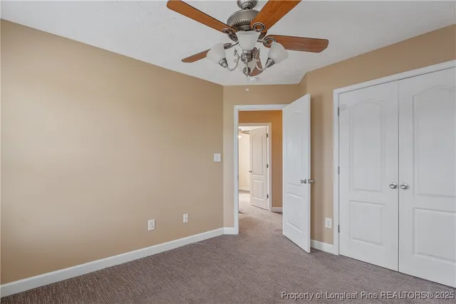 a view of a chandelier fan and entryway