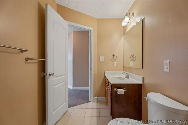 a bathroom with a sink a toilet a mirror and vanity