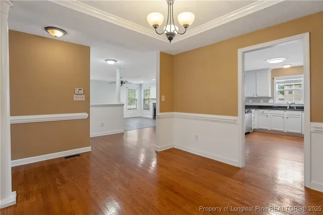 a view of a kitchen with wooden floor and a kitchen