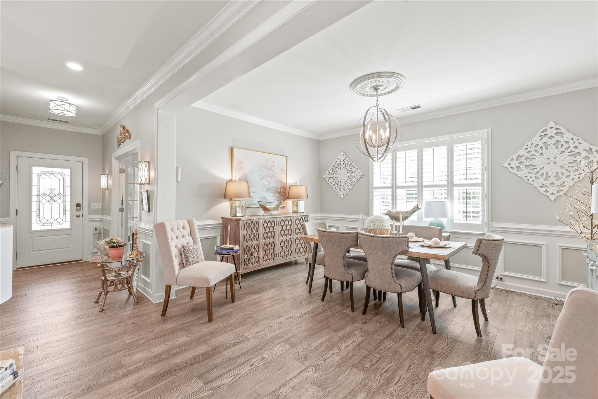 5002 Samoa Ridge Drive Lancaster, SC 29720 - Photo 5 of 45 a view of a dining room with furniture a chandelier and wooden floor