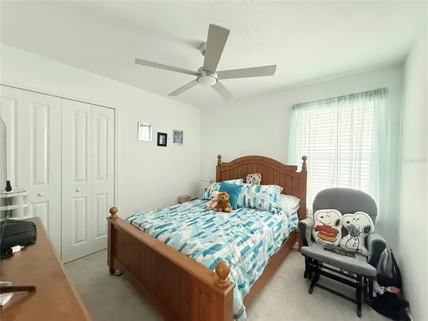 a bedroom with a bed and a couch