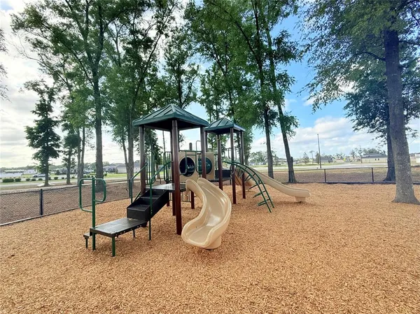 a view of a dining room with furniture large windows and wooden floor
