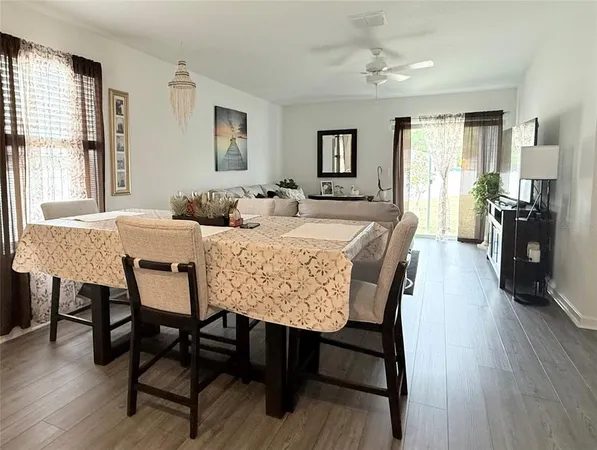 a view of a a dining room with furniture window and wooden floor