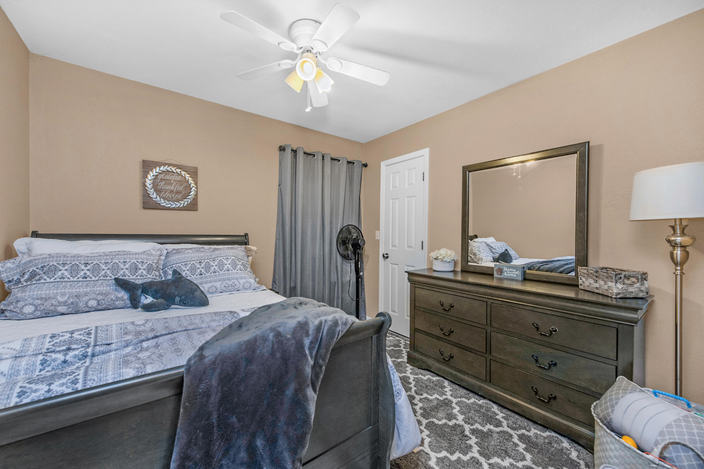 1984 Pine Ranch Drive Navarre, FL 32566 - Photo 11 of 45 a bedroom with a bed and a chandelier