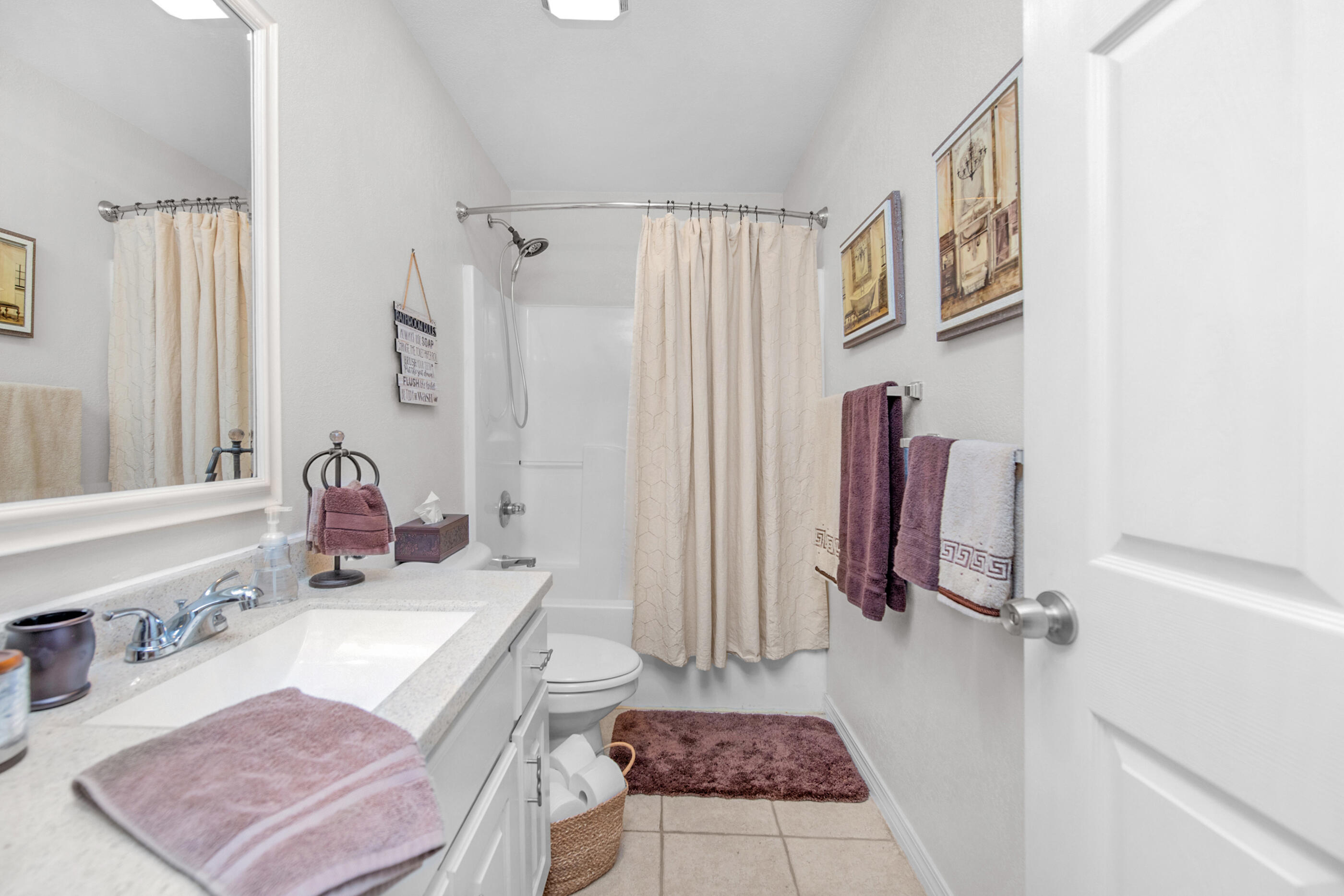 1984 Pine Ranch Drive Navarre, FL 32566 - Photo 13 of 45 a bathroom with a granite countertop sink a toilet and a shower