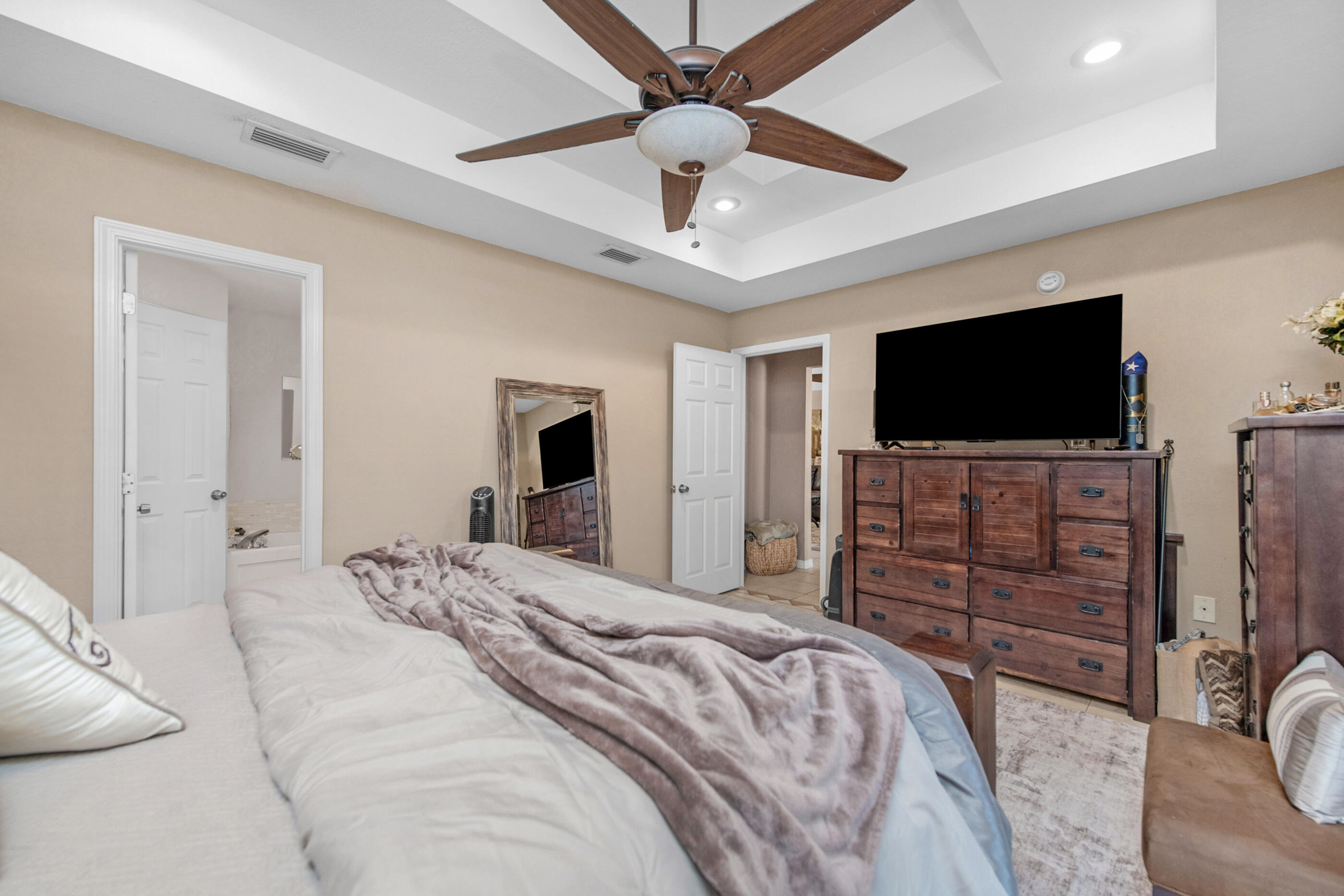 1984 Pine Ranch Drive Navarre, FL 32566 - Photo 17 of 45 a bedroom with a bed and a flat screen tv