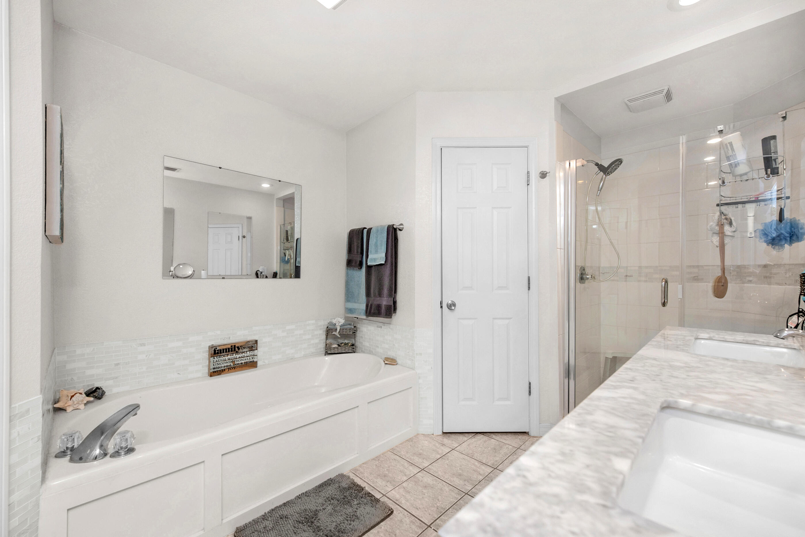 1984 Pine Ranch Drive Navarre, FL 32566 - Photo 19 of 45 a bathroom with a tub a sink and a shower