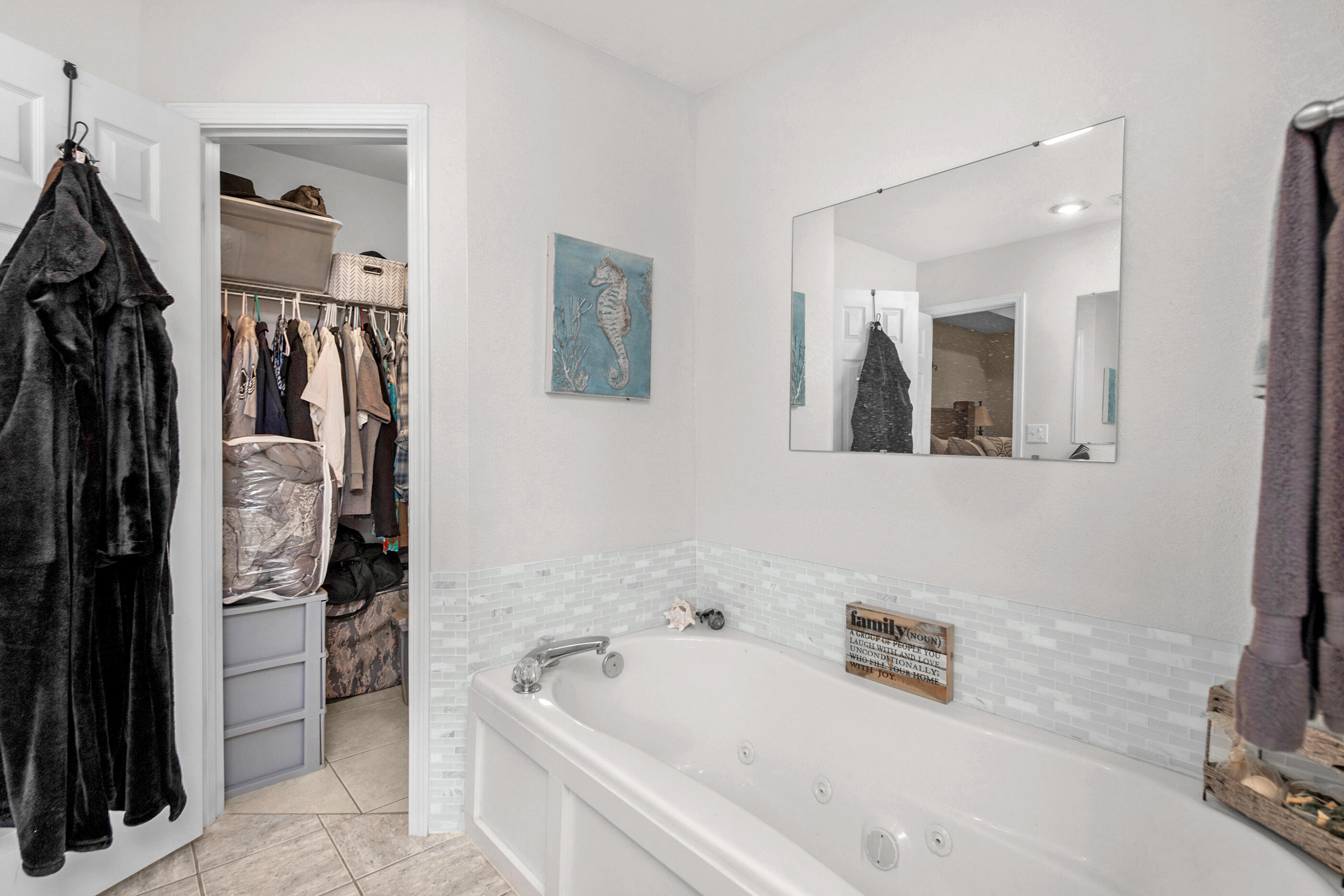 1984 Pine Ranch Drive Navarre, FL 32566 - Photo 20 of 45 a bathroom with a tub a sink and a mirror