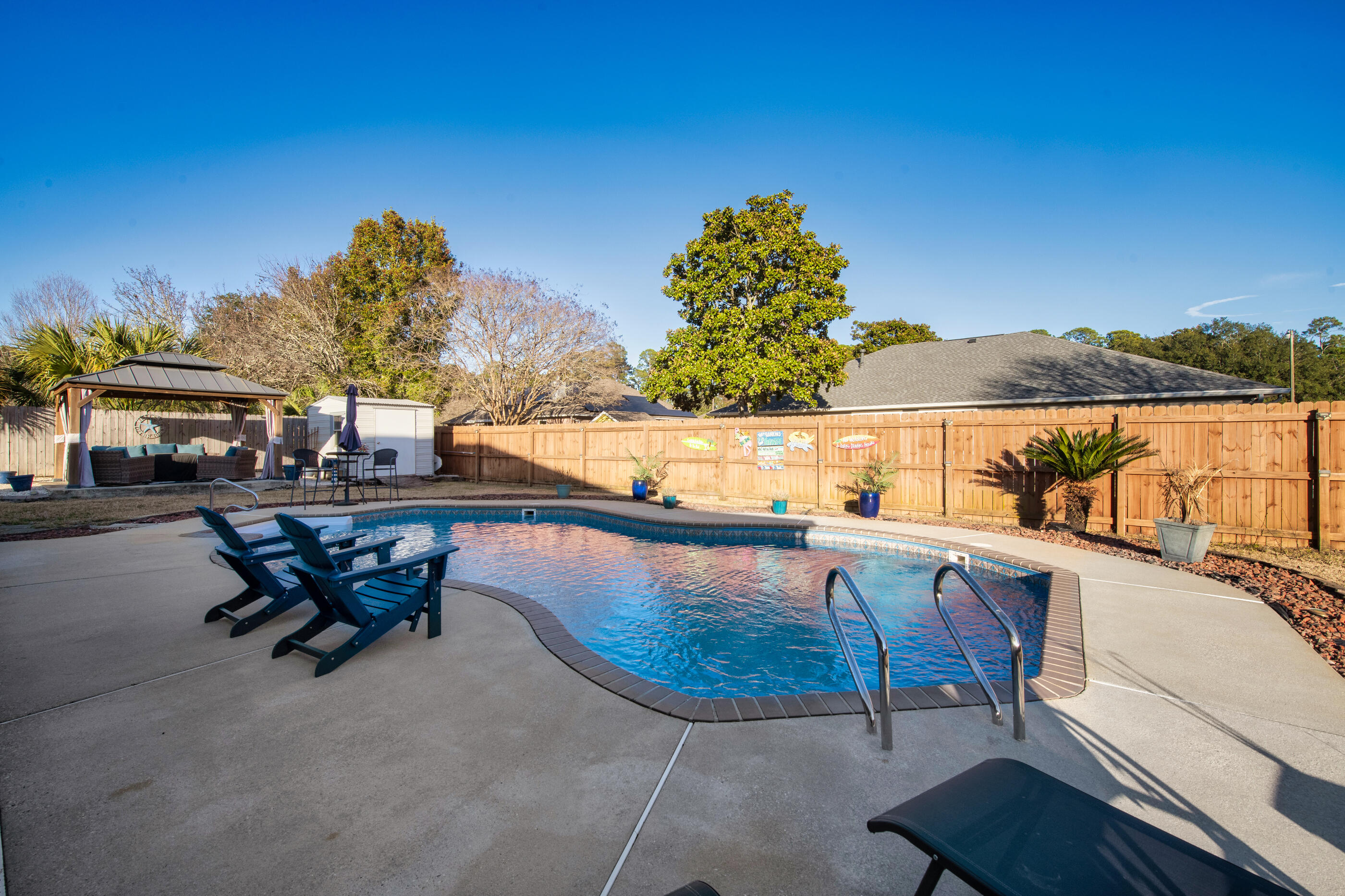 1984 Pine Ranch Drive Navarre, FL 32566 - Photo 32 of 45 a view of a swimming pool with a lounge chair
