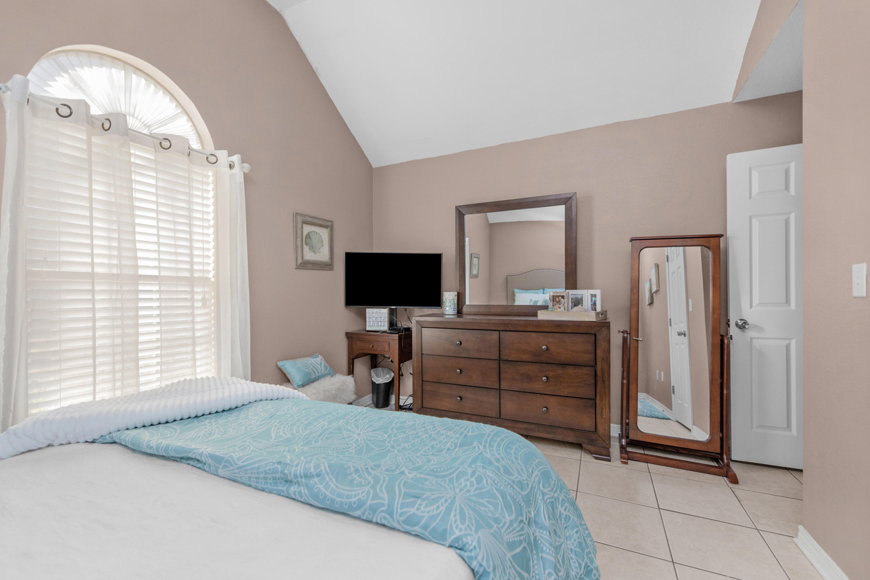 1984 Pine Ranch Drive Navarre, FL 32566 - Photo 10 of 45 a bedroom with a bed and a flat screen tv