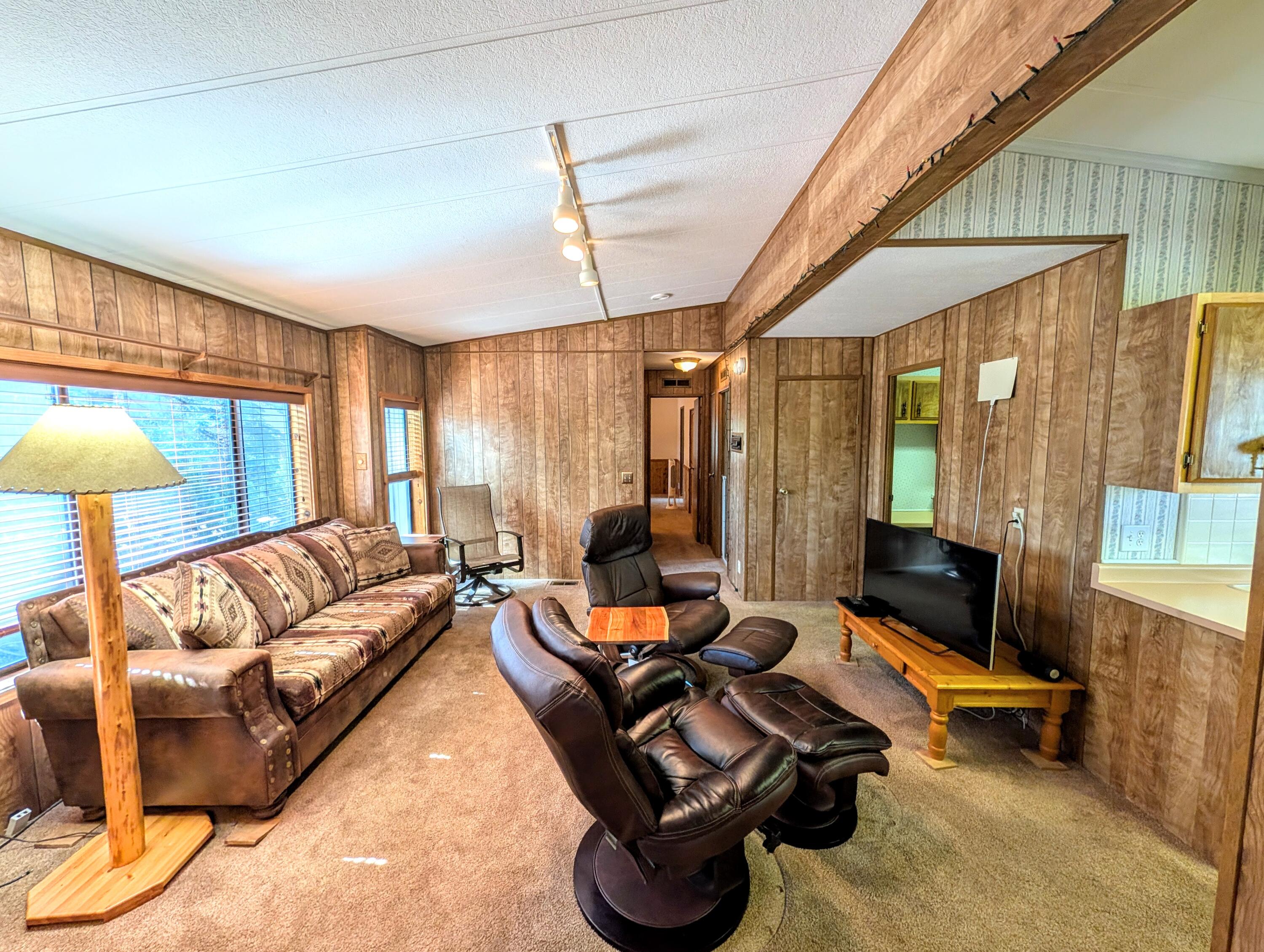 20735 Valentine Street, Unit 6 Bend, OR 97701 - Photo 2 of 26 a living room with furniture gym equipment and a large window