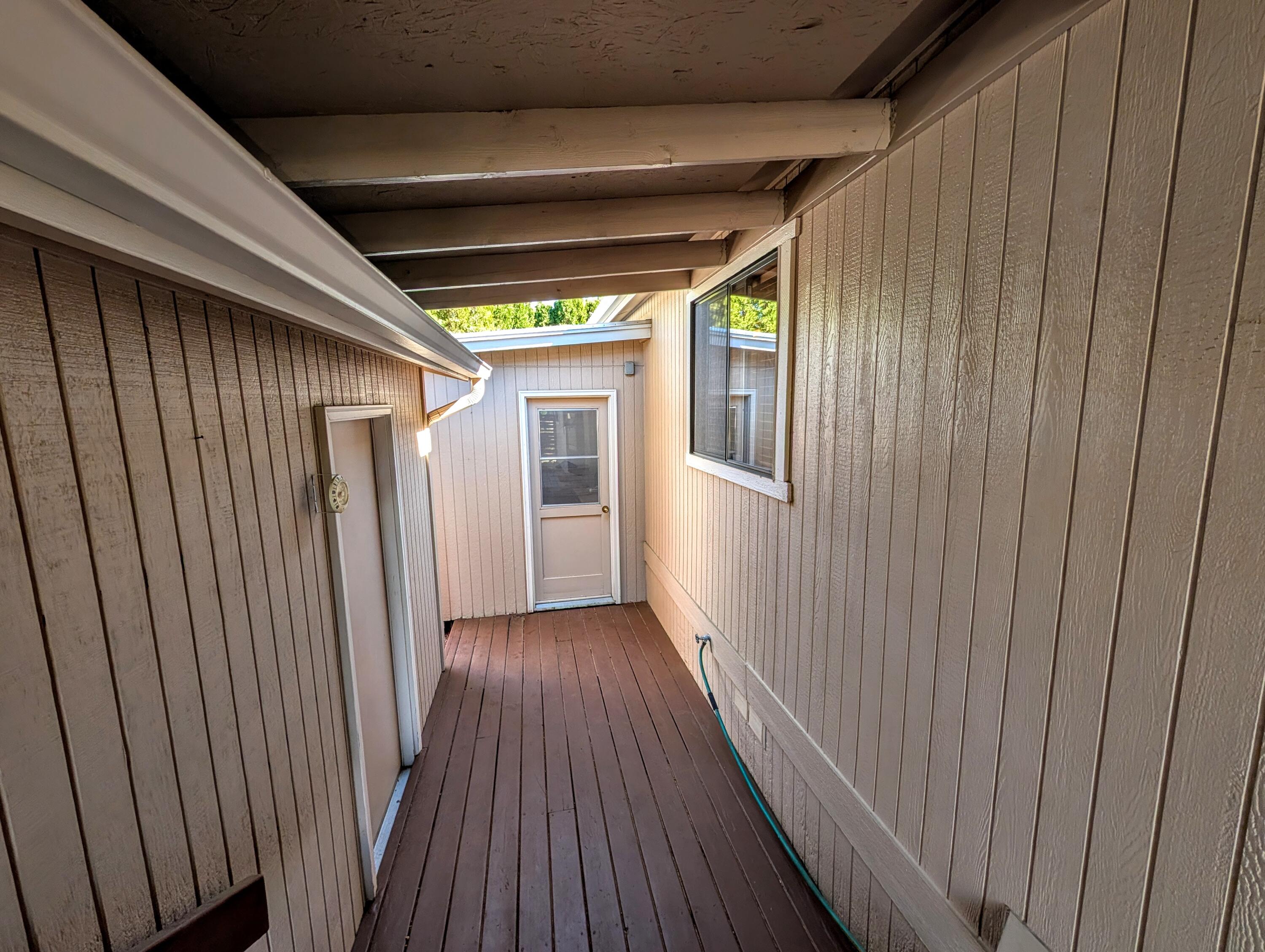 20735 Valentine Street, Unit 6 Bend, OR 97701 - Photo 23 of 26 a view of a hallway with wooden floor and staircase