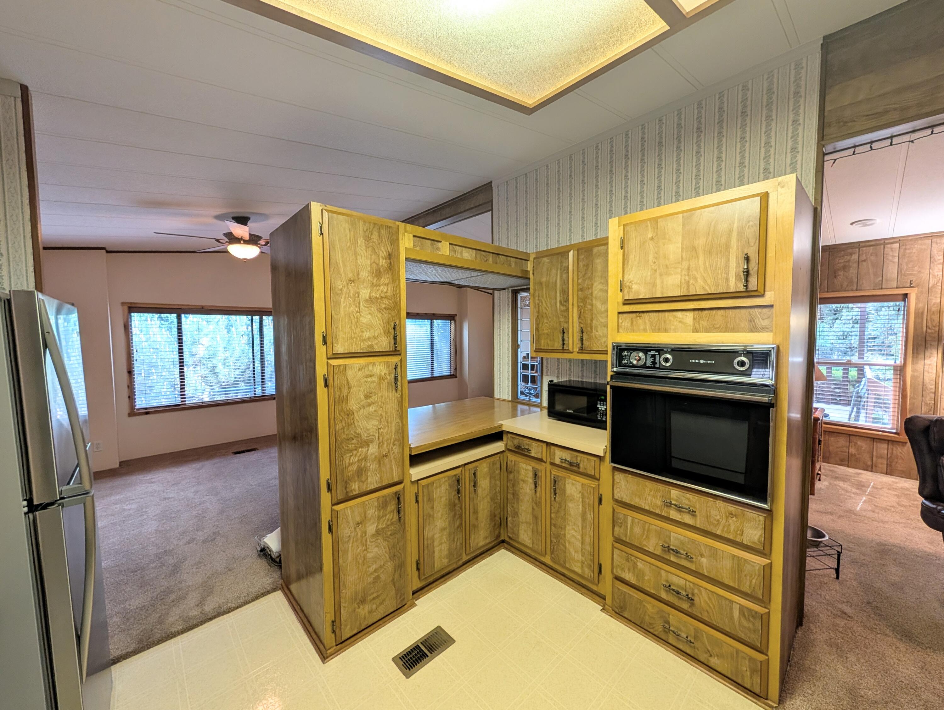 20735 Valentine Street, Unit 6 Bend, OR 97701 - Photo 4 of 26 a kitchen with stainless steel appliances granite countertop a refrigerator a stove and a sink