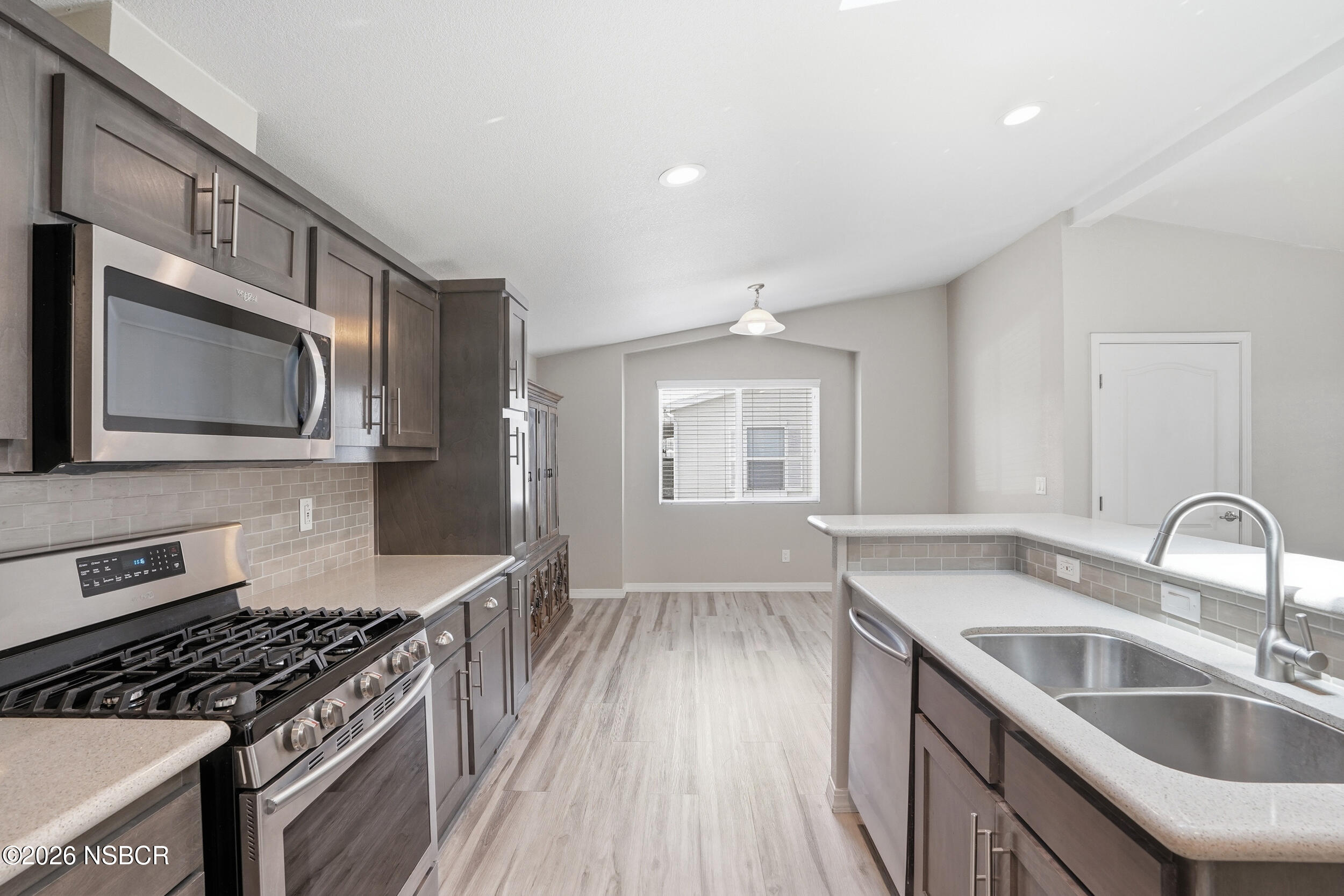 500 Atascadero Road, Unit M3 Morro Bay, CA 93442 - Photo 10 of 29 a kitchen with granite countertop a sink wooden floor and stainless steel appliances