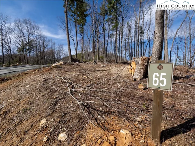 a sign board with a tree in the background