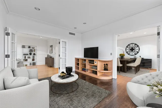 a living room with furniture and wooden floor