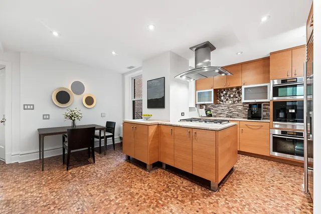 a spacious bedroom with a bed and a dresser