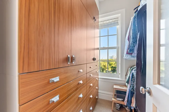 a living room with furniture a window and a flat screen tv