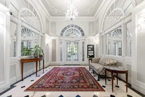 a view of an entryway with a chandelier and wooden floor