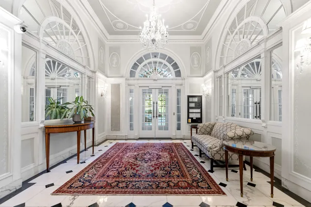 a view of an entryway with a chandelier and wooden floor