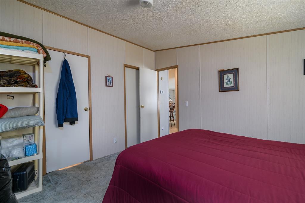 122 Grice Road Ringgold, LA 71068 - Photo 12 of 26 Interior room featuring vertical wall paneling and a textured ceiling