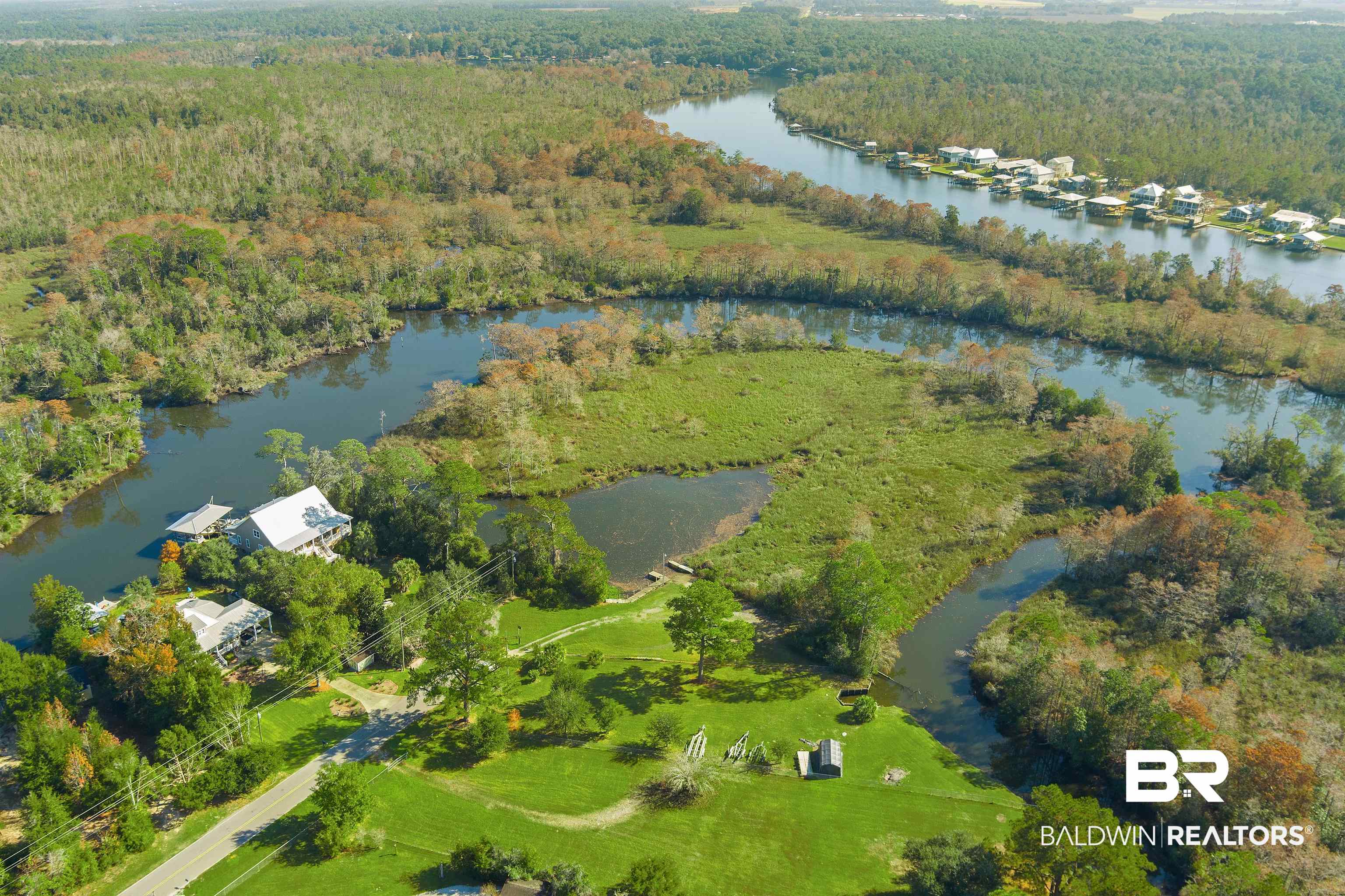 11236 Wren Avenue Fairhope, AL 36532 - Photo 33 of 35 Aerial view of property and surrounding area with a heavily wooded area and a large body of water