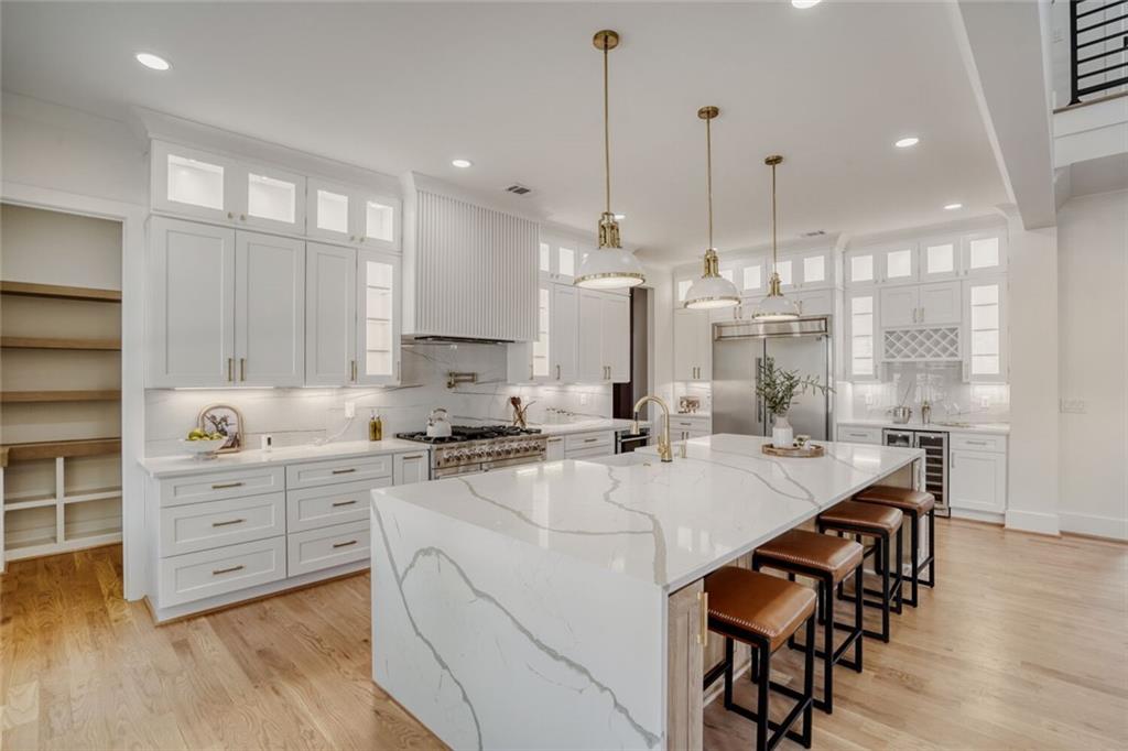 936 Cooper Road Loganville, GA 30052 - Photo 13 of 34 a large kitchen with kitchen island a island a stove a table and chairs in it