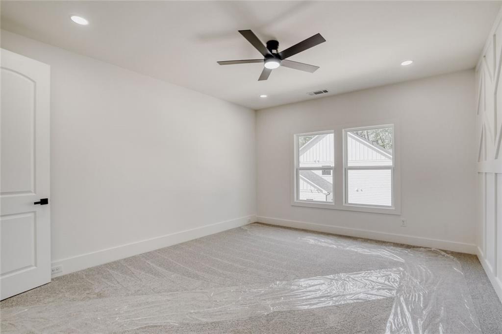 936 Cooper Road Loganville, GA 30052 - Photo 28 of 34 an empty room with windows and fan