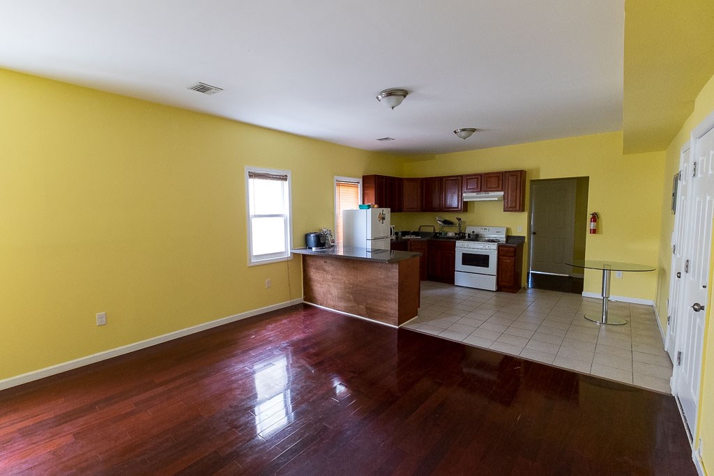 a view of a kitchen with a sink and a refrigerator