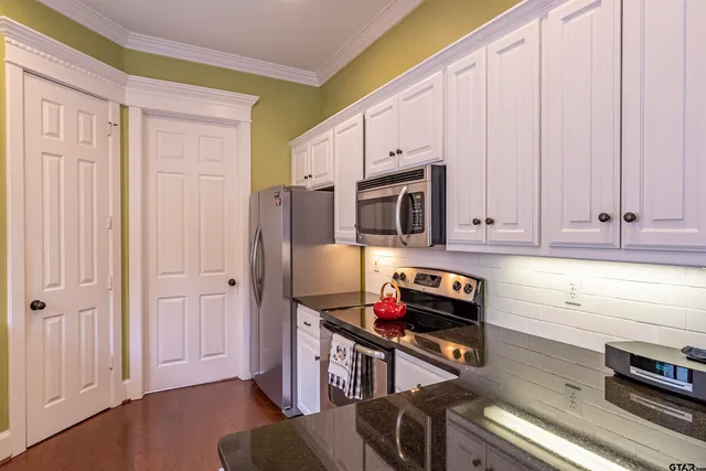 a kitchen with stainless steel appliances a stove a microwave and a refrigerator