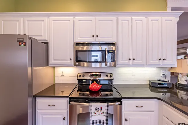 a kitchen with granite countertop a stove and a sink