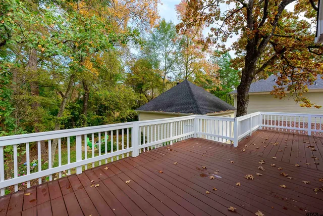a view of balcony with wooden floor and fence