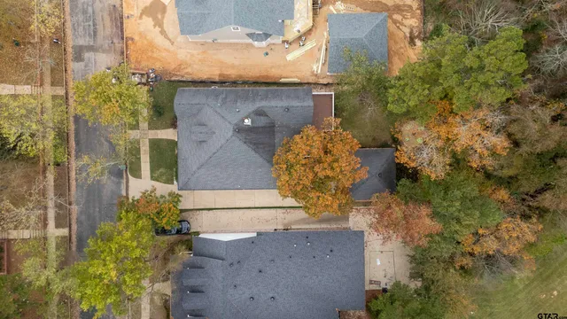 an aerial view of a house with a yard