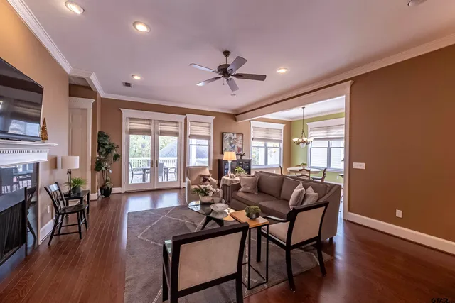 a living room with furniture a fireplace and wooden floor