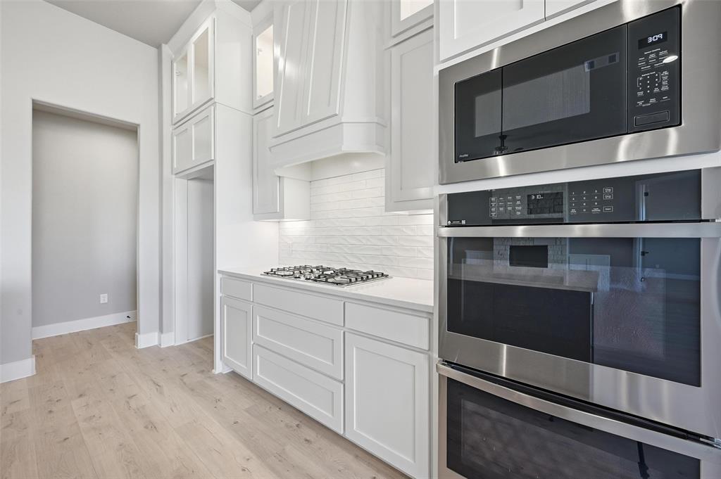 108 Rocky Top Azle, TX 76020 - Photo 8 of 40 a kitchen with stainless steel appliances a stove and a microwave