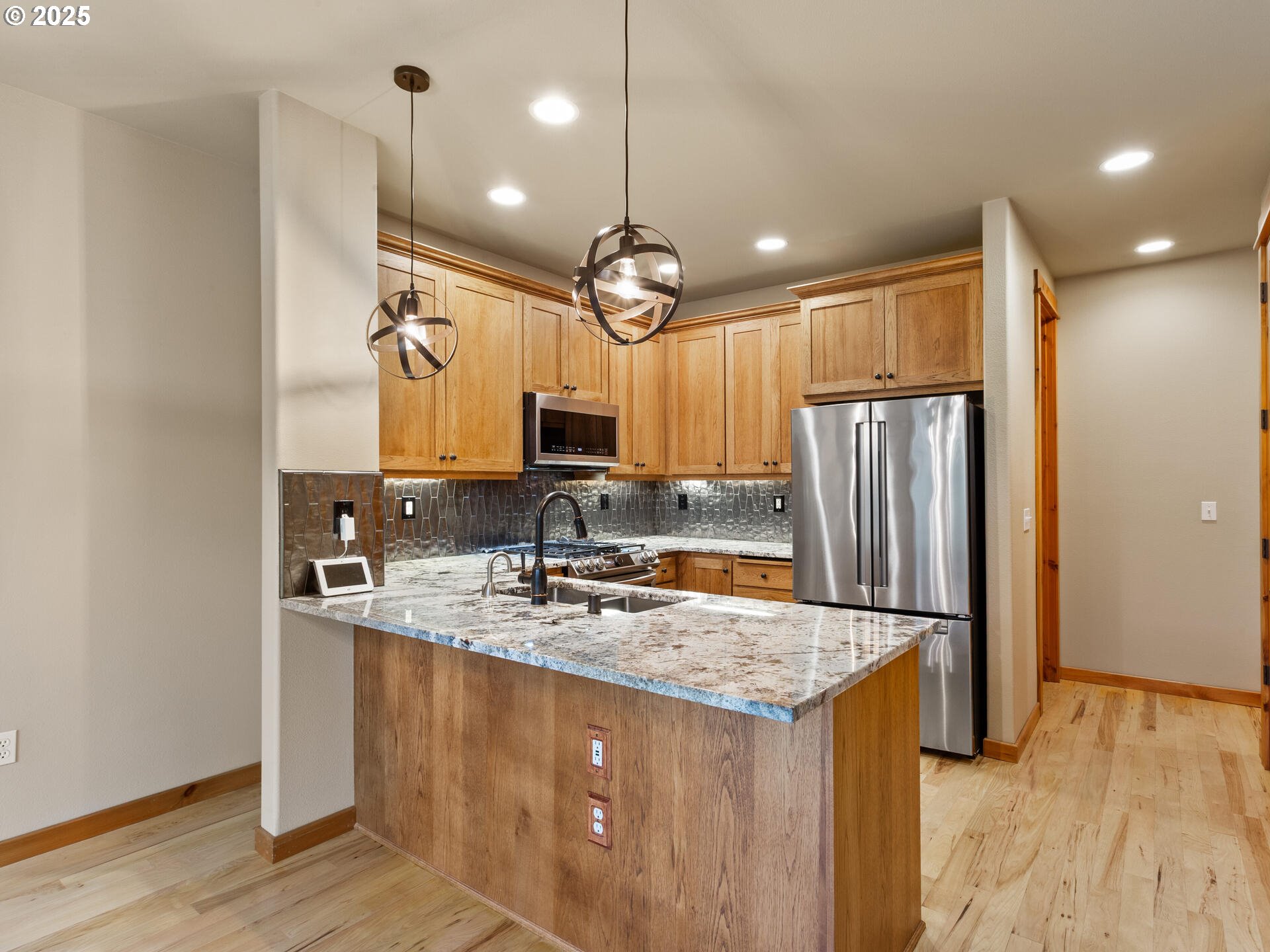 12800 Northeast Salmon Creek Avenue, Unit 119 Vancouver, WA 98686 - Photo 11 of 46 a kitchen with kitchen island granite countertop a sink cabinets and refrigerator