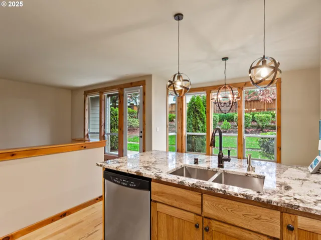 a kitchen with stainless steel appliances granite countertop a refrigerator and a cabinets