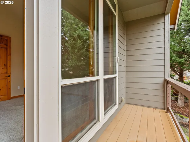 a view of balcony with wooden floor and fence
