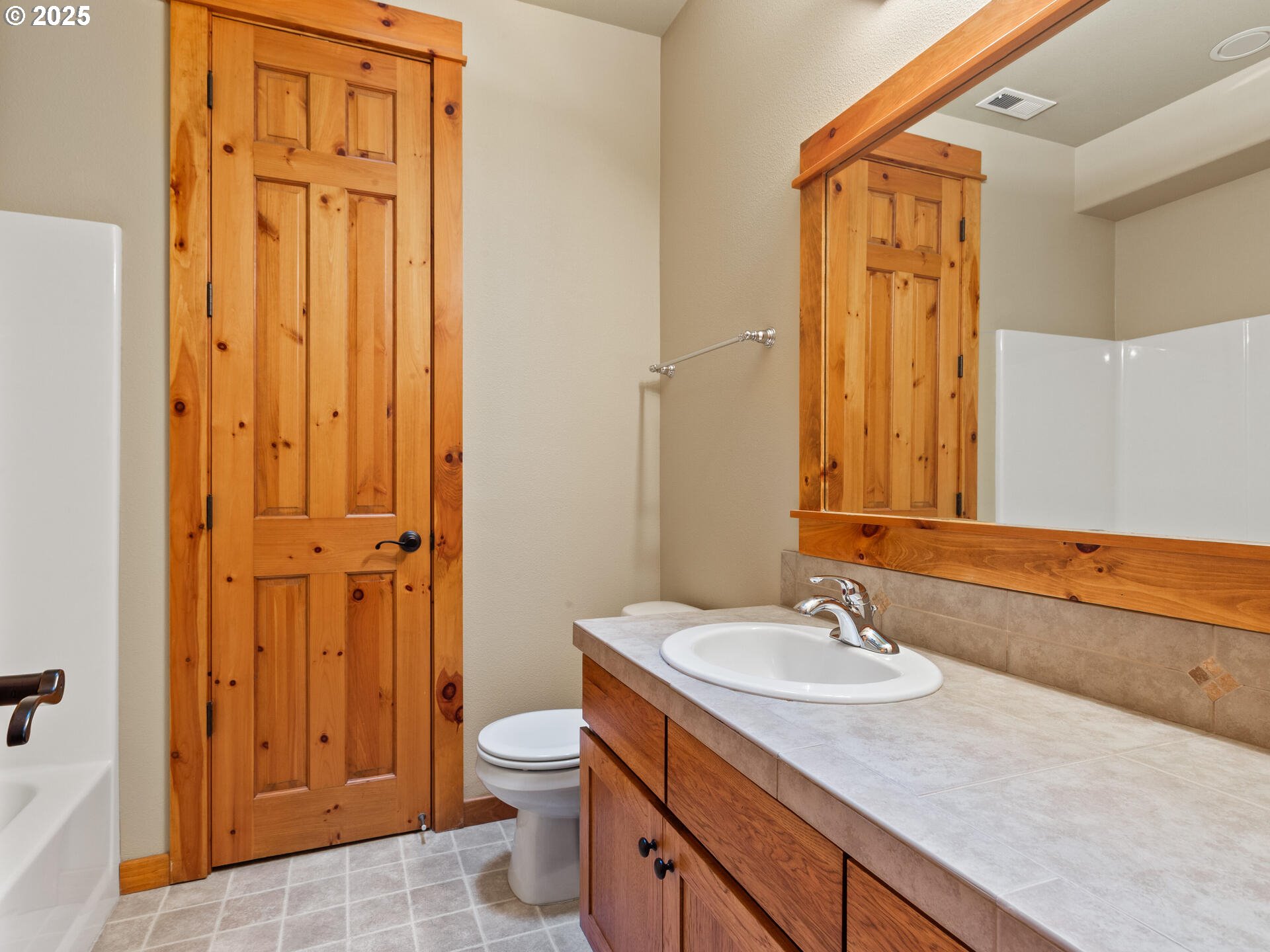 12800 Northeast Salmon Creek Avenue, Unit 119 Vancouver, WA 98686 - Photo 40 of 46 a bathroom with a granite countertop sink toilet and shower