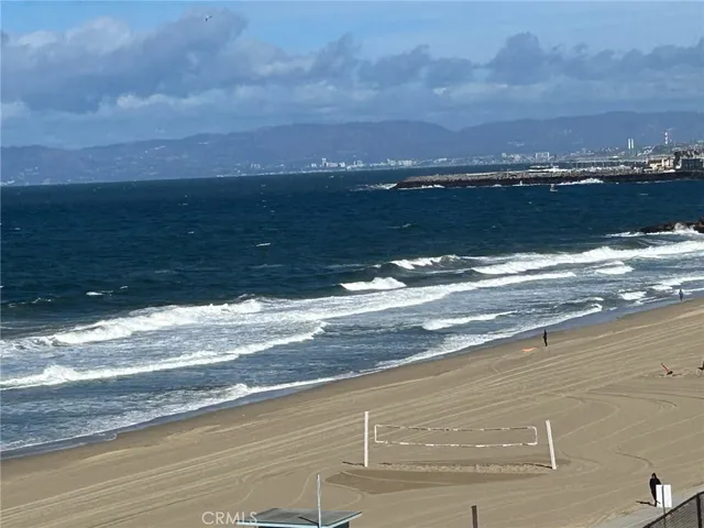 a front view of a building with palm trees