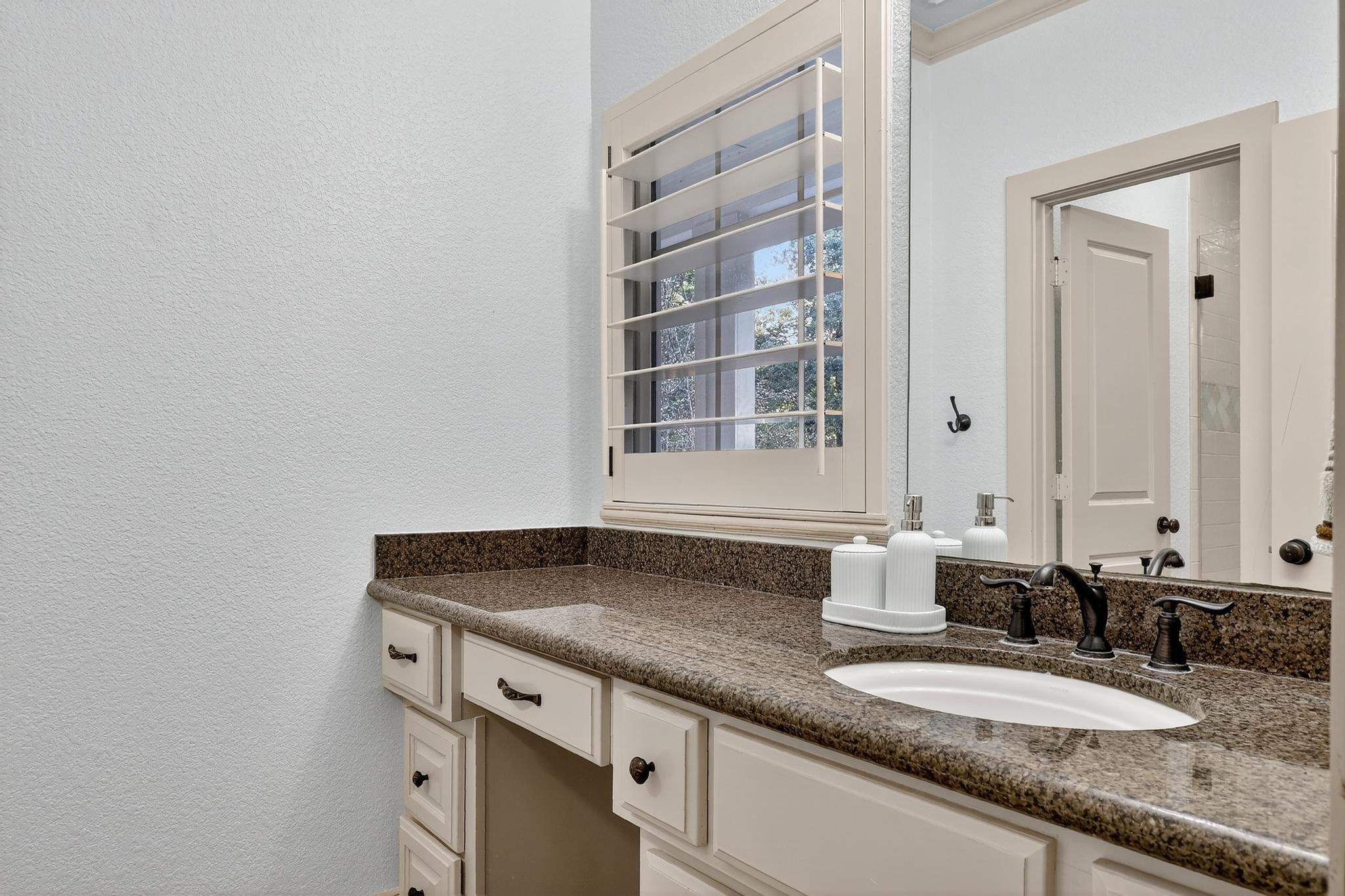 420 Whispering Meadow Magnolia, TX 77355 - Photo 26 of 44 a bathroom with a granite countertop sink and a mirror