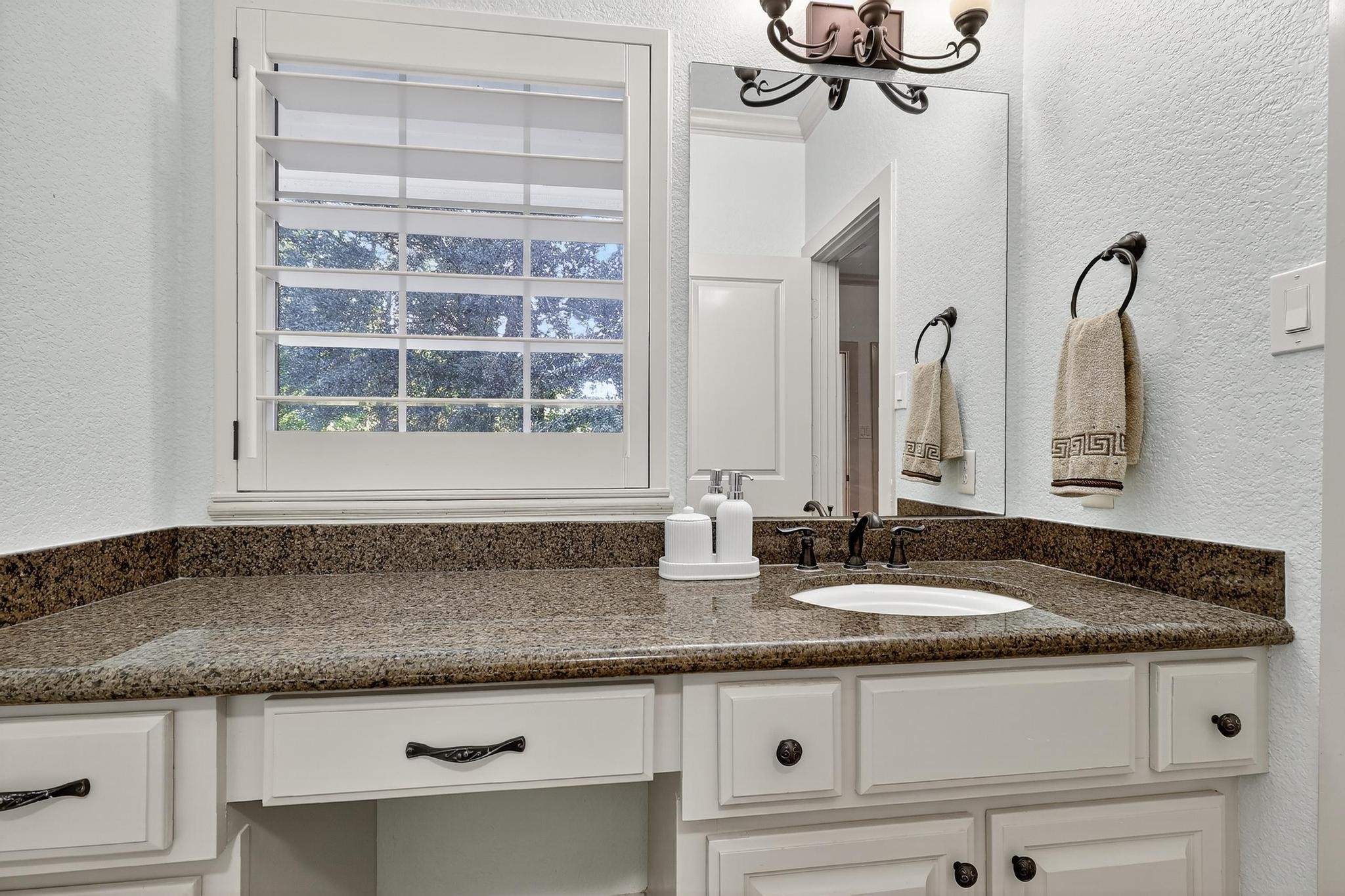 420 Whispering Meadow Magnolia, TX 77355 - Photo 27 of 44 a kitchen with granite countertop a sink and a window