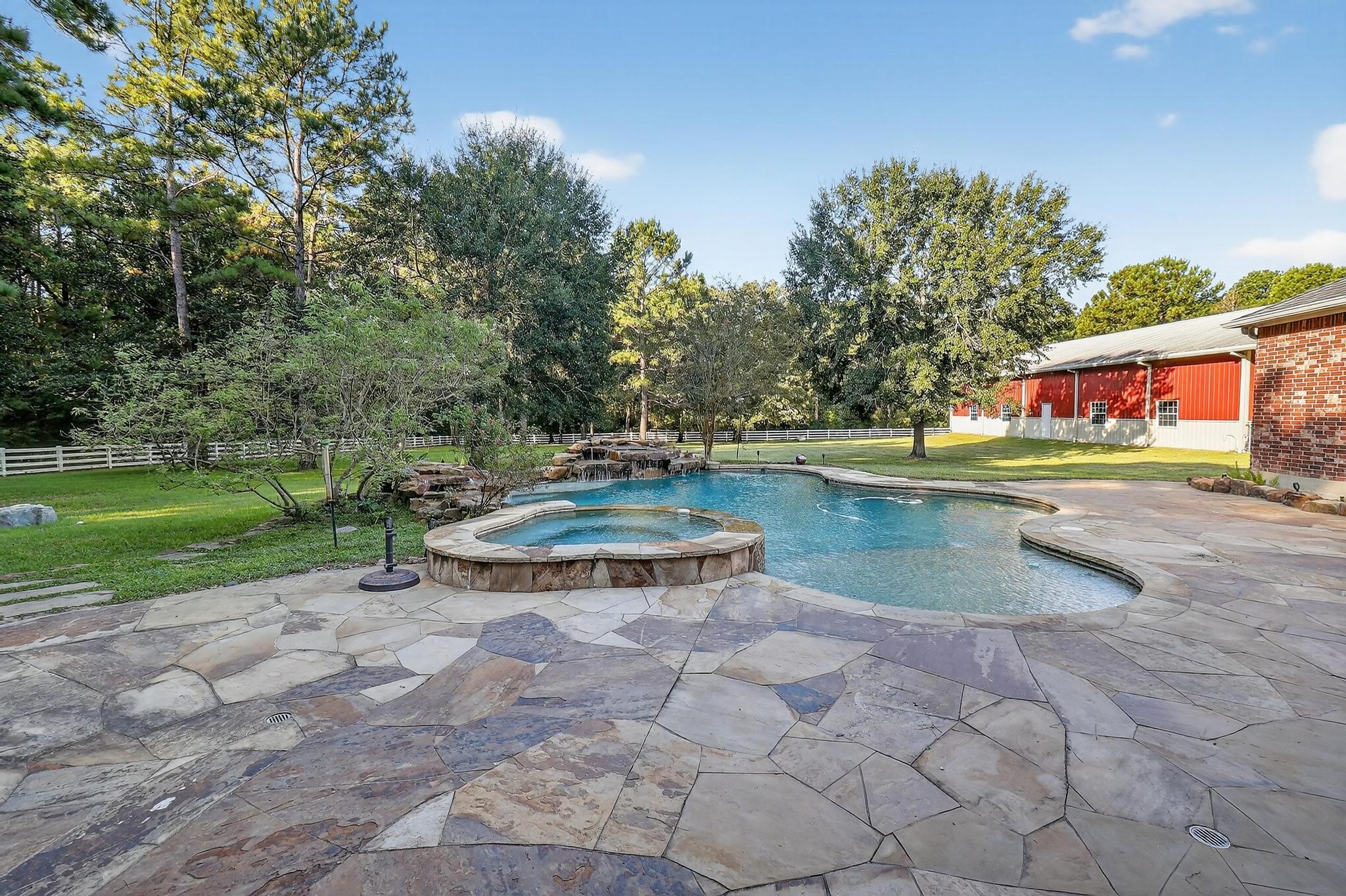 420 Whispering Meadow Magnolia, TX 77355 - Photo 38 of 44 a view of a swimming pool with a yard and plants