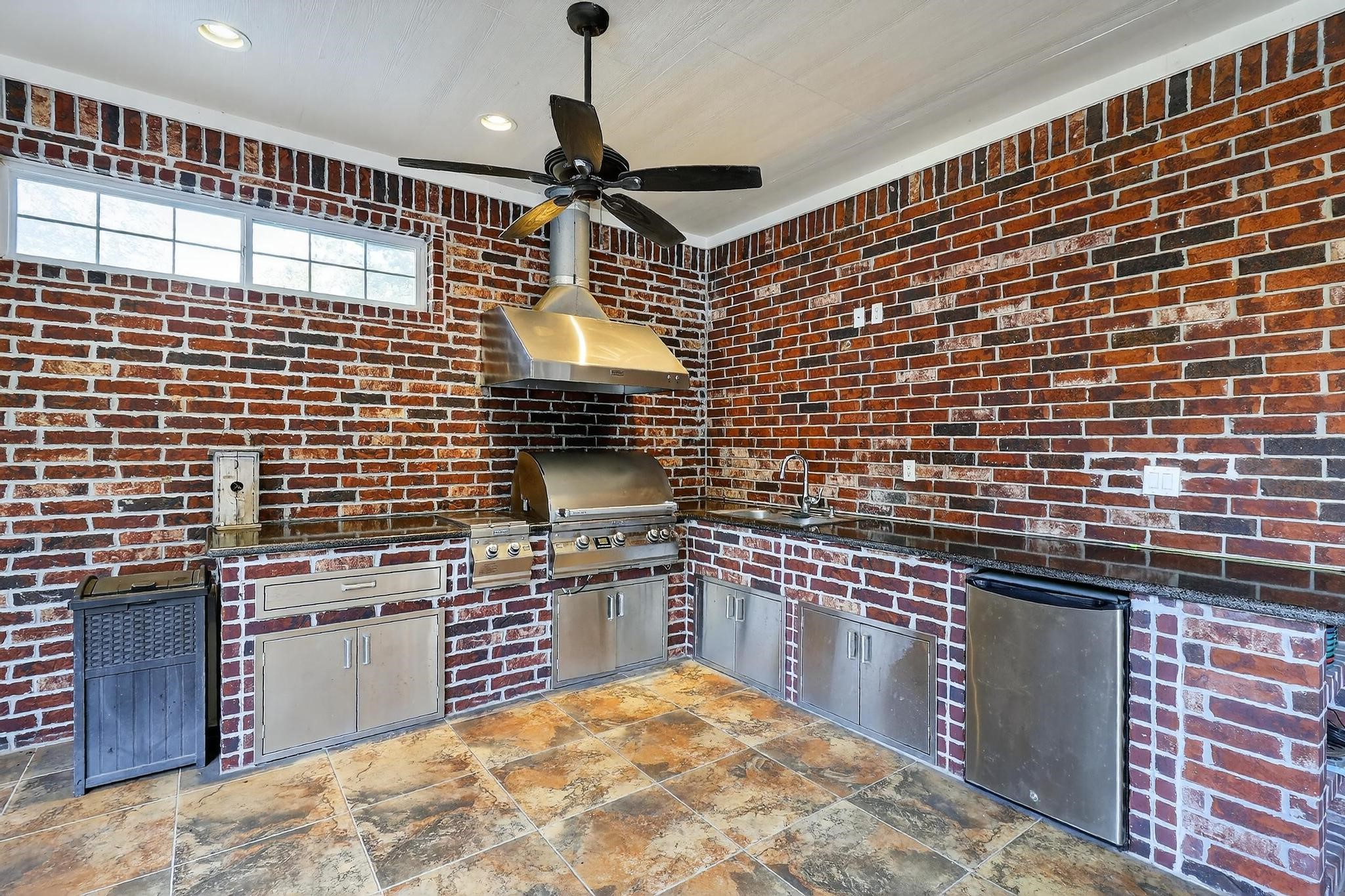 420 Whispering Meadow Magnolia, TX 77355 - Photo 39 of 44 a kitchen with stainless steel appliances granite countertop a sink stove and cabinets